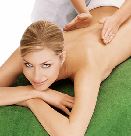 Woman on a massage bed, smiling at the camera
